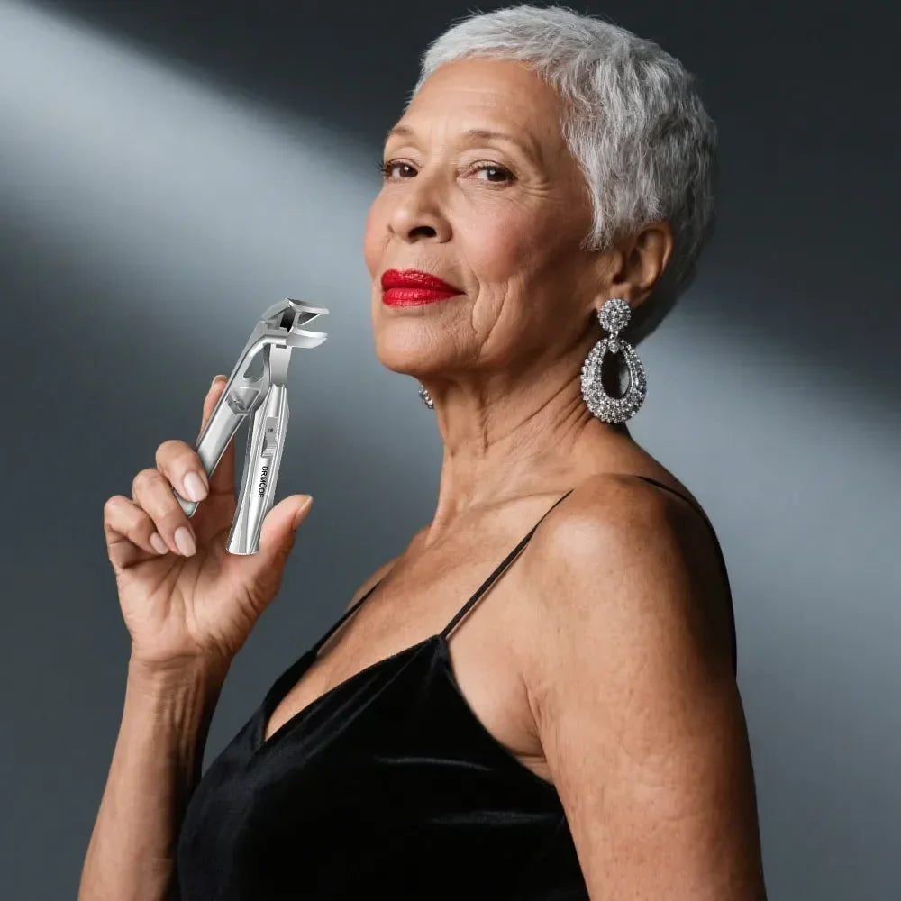 Elegant senior woman in black dress holding large stainless steel nail clippers