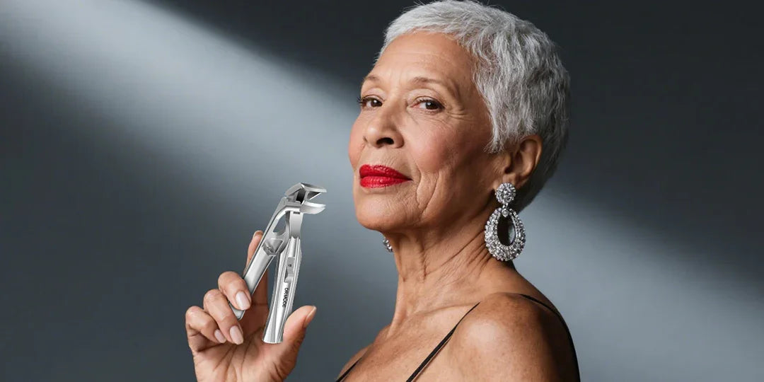 Elegant older woman holding precision stainless steel nail clippers, stylish grooming tool