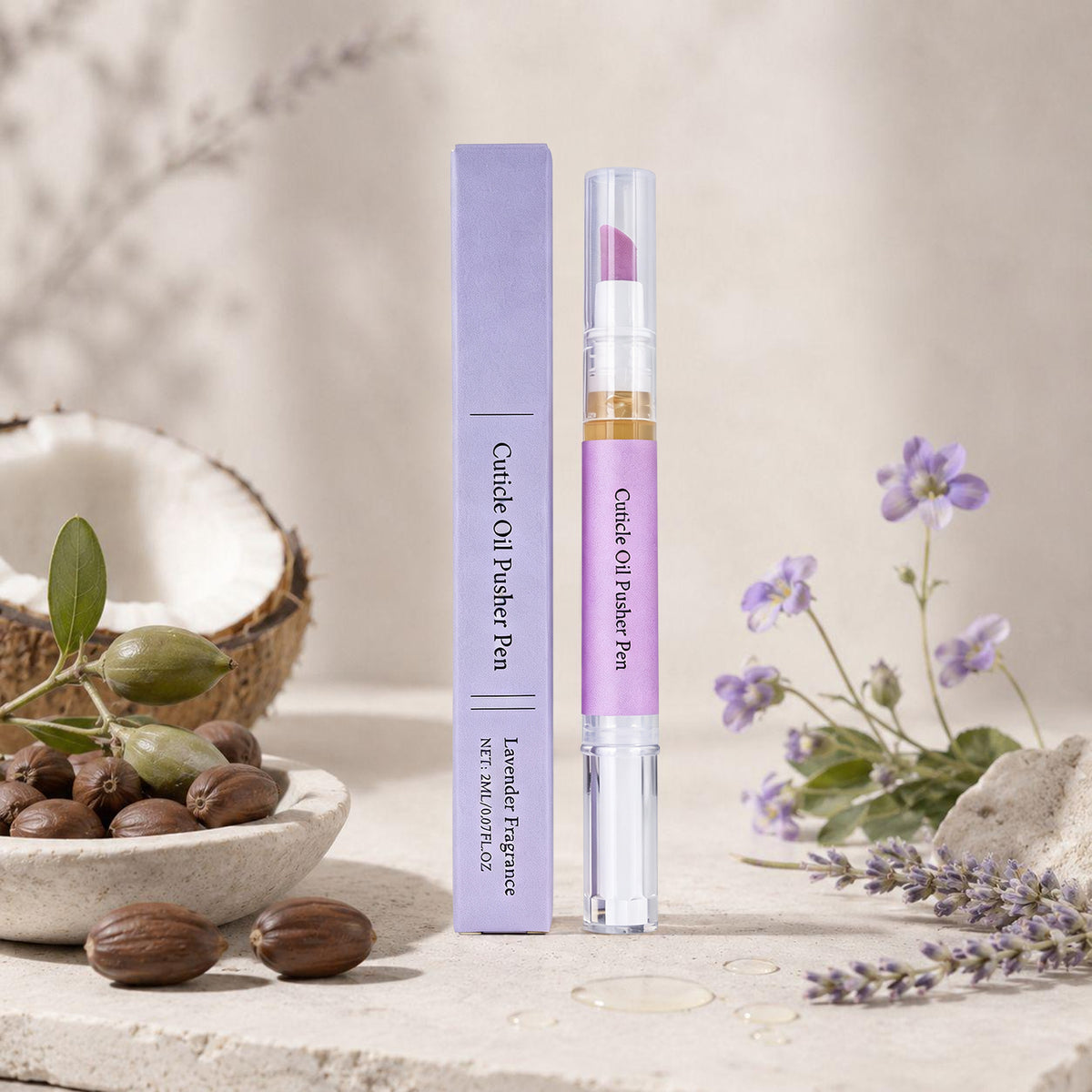 Cuticle oil pen surrounded by natural ingredients including coconut, jojoba beads and fresh lavender flowers
